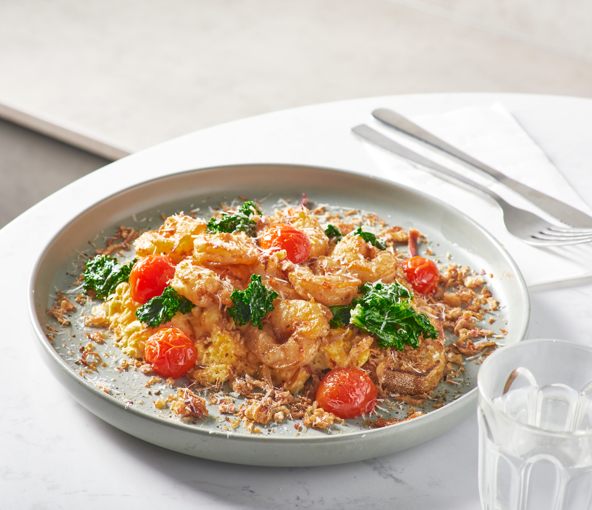 Prawn scrambled eggs with kale and cherry tomatoes on sourdough