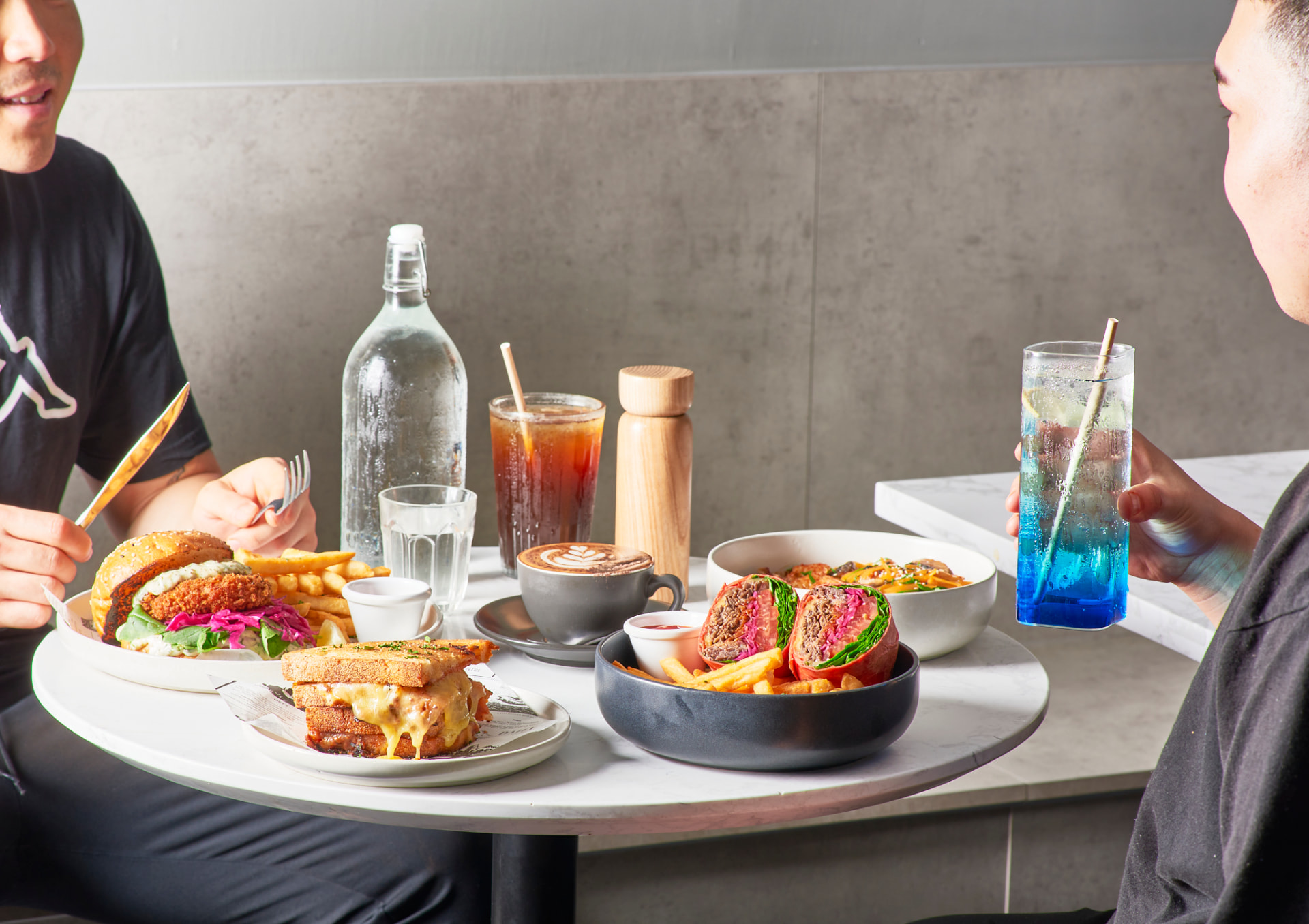 Two guests sharing brunch plates at Boom Cafe & Dining
