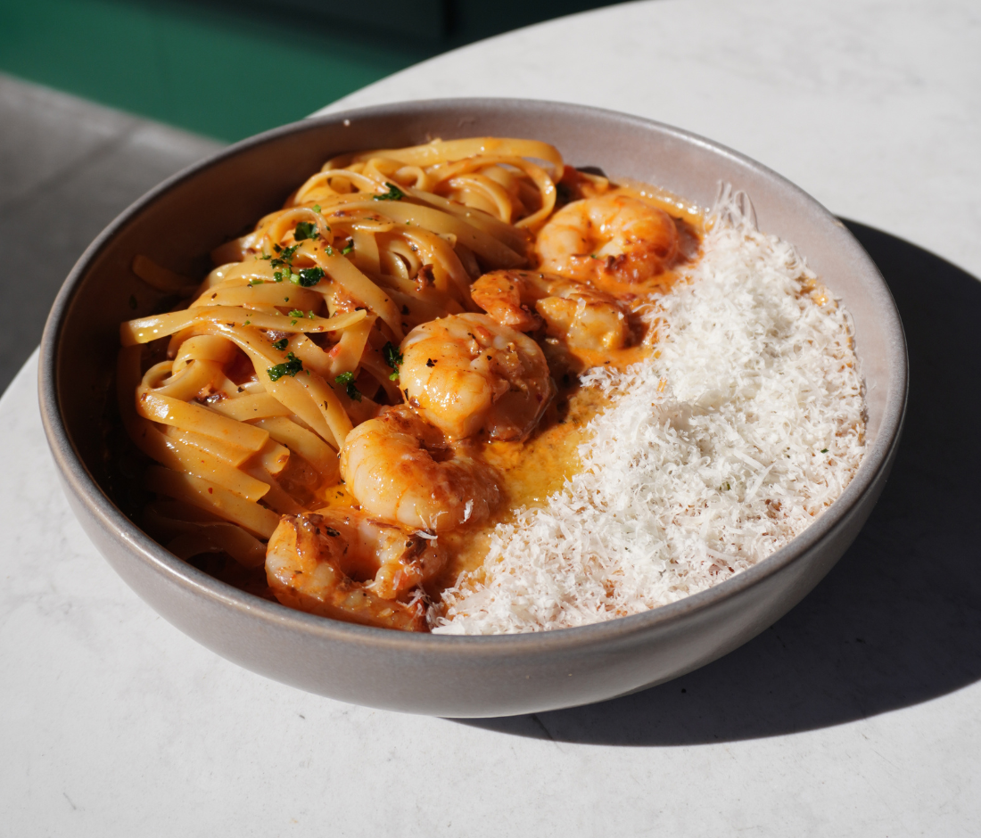 Rosé prawn pasta with parmesan in a ceramic bowl